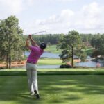 Golfer looking thoughtfully at the course, highlighting the mental aspect of learning golf