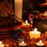 Ofrenda with candles, flowers, and photos