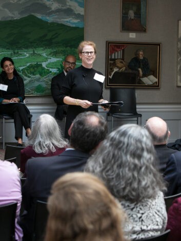 Smiling woman in glasses at a conference