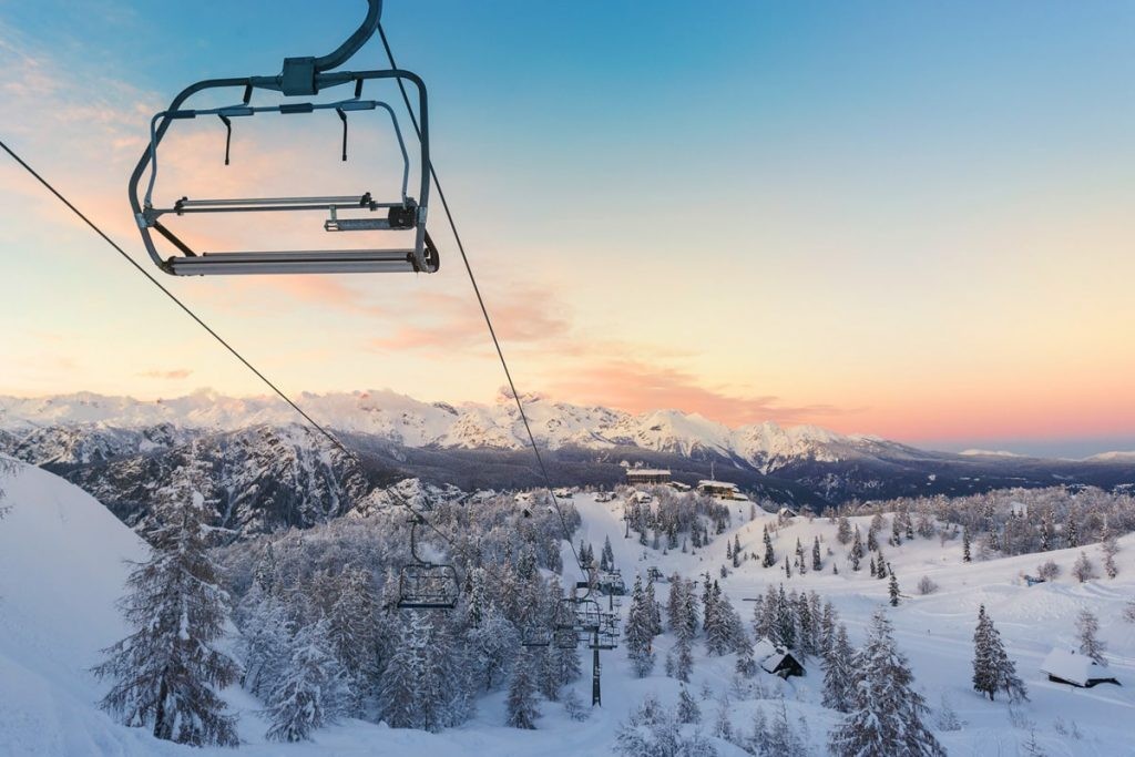 Adult beginner skier smiling on a gentle slope