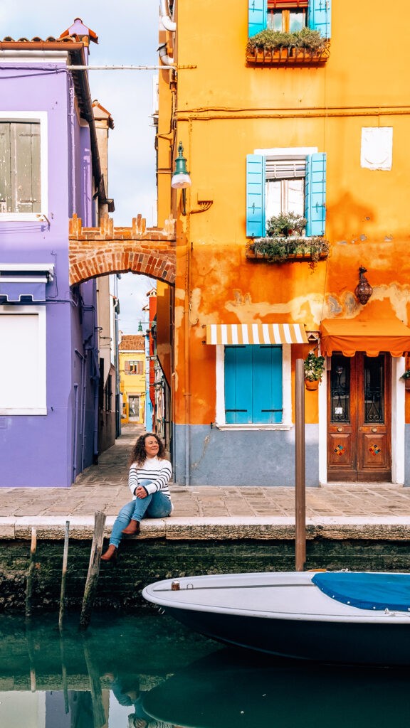 Michele Frolla in Venice, Italy, considering if Italian is hard to learn while sitting by a canal.