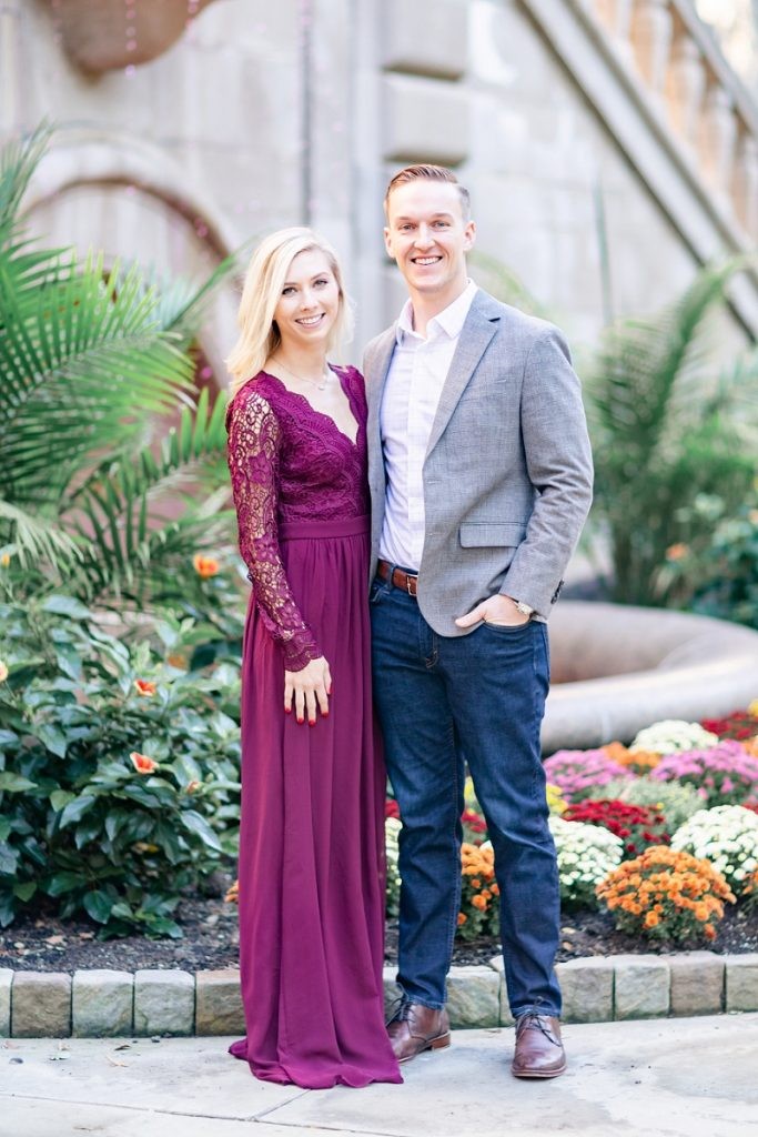 Jenna and Logan pose elegantly in front of the Cathedral of Learning's stone facade during their engagement photoshoot.