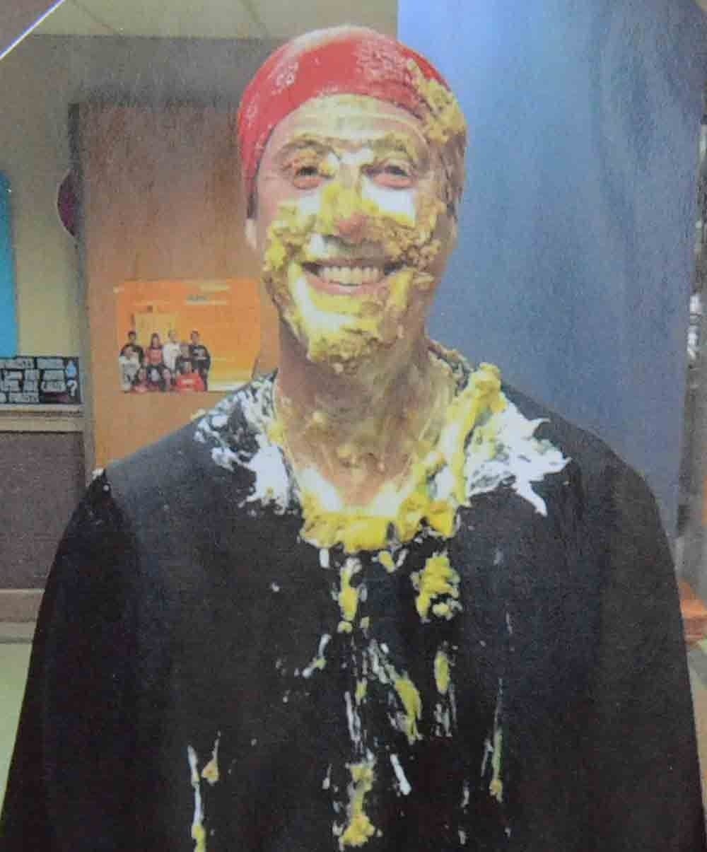 Principal Stephen Mahoney, in a photo taken on "Pi Day." The student who can recite the most digits in the number π gets to throw a pie in Mahoney's face. "We like to have fun," he says. (Photo by Emily Hanford, of a photo on Mahoney's office door)