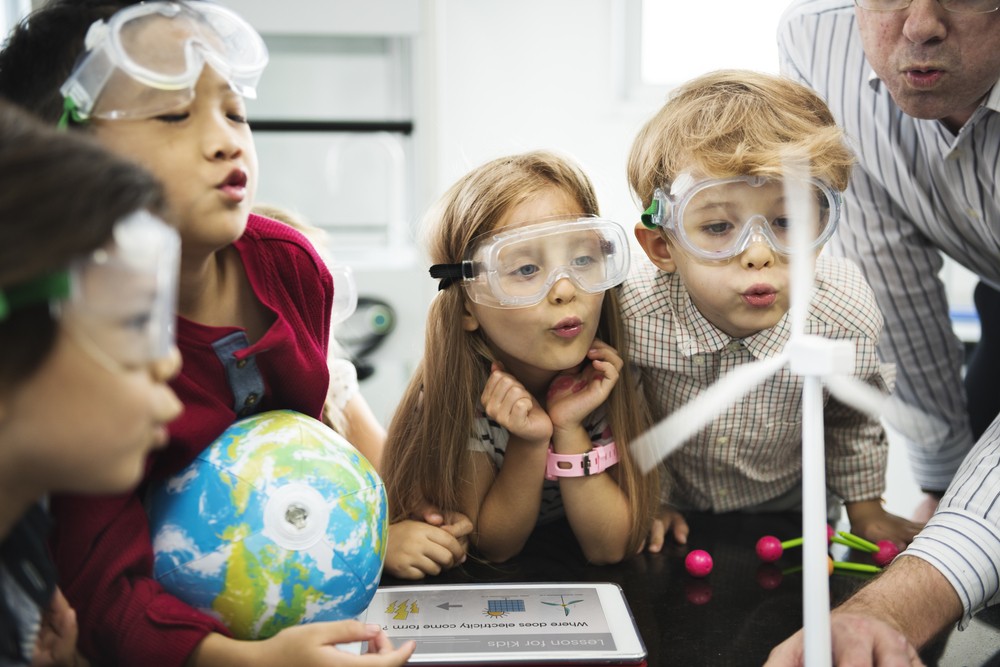 Elementary students engaged in a hands-on science experiment, embodying discovery learning through active participation and exploration.