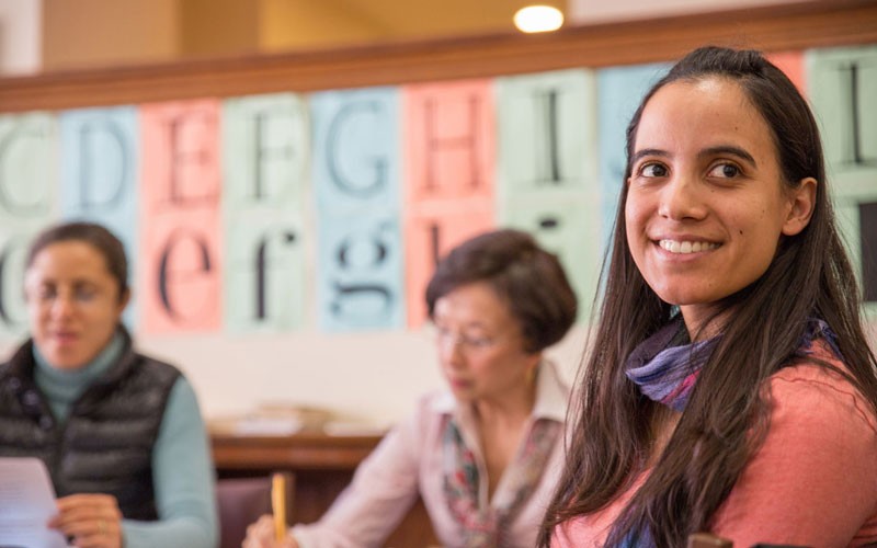 Diverse adults learning English in a classroom setting at NYPL.