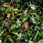 Roasted vegetables in a pan, seasoned with herbs and spices