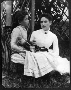 Helen Keller with Anne in 1888 in a garden setting