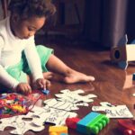 Child engaging in early learning activities with puzzles and alphabet letters