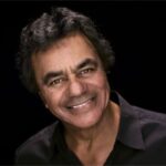 Johnny Mathis performing on stage, captivating his audience with his timeless voice and stage presence.