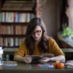 Person engrossed in a book, symbolizing a love for learning