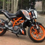 My KTM 390 Duke motorcycle, a 2015 model, parked outdoors showcasing its sporty design.