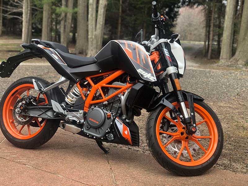 My KTM 390 Duke motorcycle, a 2015 model, parked outdoors showcasing its sporty design.