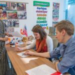 Diverse group of students participating in a learn language program at the Foreign Service Institute, engaging in classroom activities.