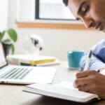 A person using shorthand to take notes in a meeting.