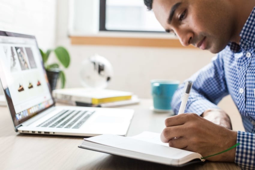 A person using shorthand to take notes in a meeting.