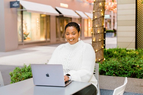 Student Alisha Small smiling in an online class setting, highlighting the accessibility of digital education resources.