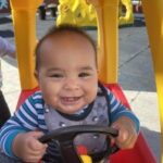 Infant exploring toys in a nurturing preschool environment