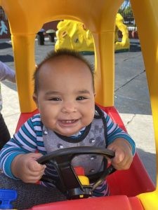 Infant exploring toys in a nurturing preschool environment