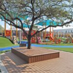 Aerial view of the Awty Early Learning Campus showcasing the U-shaped building layout and expansive outdoor play area.