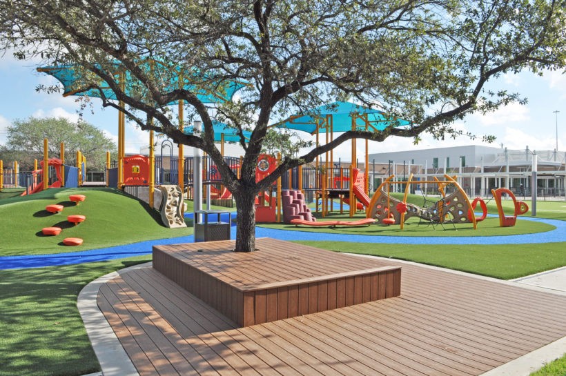 Aerial view of the Awty Early Learning Campus showcasing the U-shaped building layout and expansive outdoor play area.