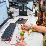 A student learning about producing electricity by using fruit
