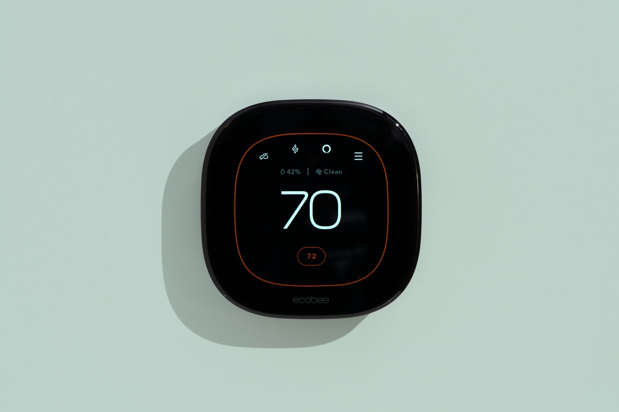 A square-shaped Ecobee smart thermostat set to 70 degrees.