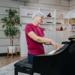 Woman immersed in piano playing, showcasing the passion and focus required to learn piano.