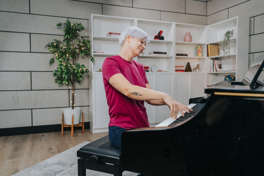 Woman immersed in piano playing, showcasing the passion and focus required to learn piano.