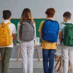 A group of children with backpacks standing together