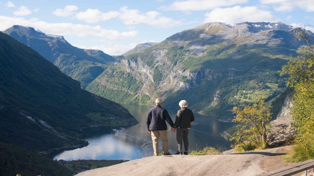 Couple on a mountain viewpoint enjoying the scenery and each other's company.