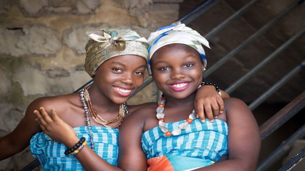 African women in traditional dress, showcasing the universal language of smiling.