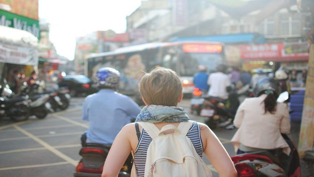 Woman walking on a busy street, representing confidence and capability.