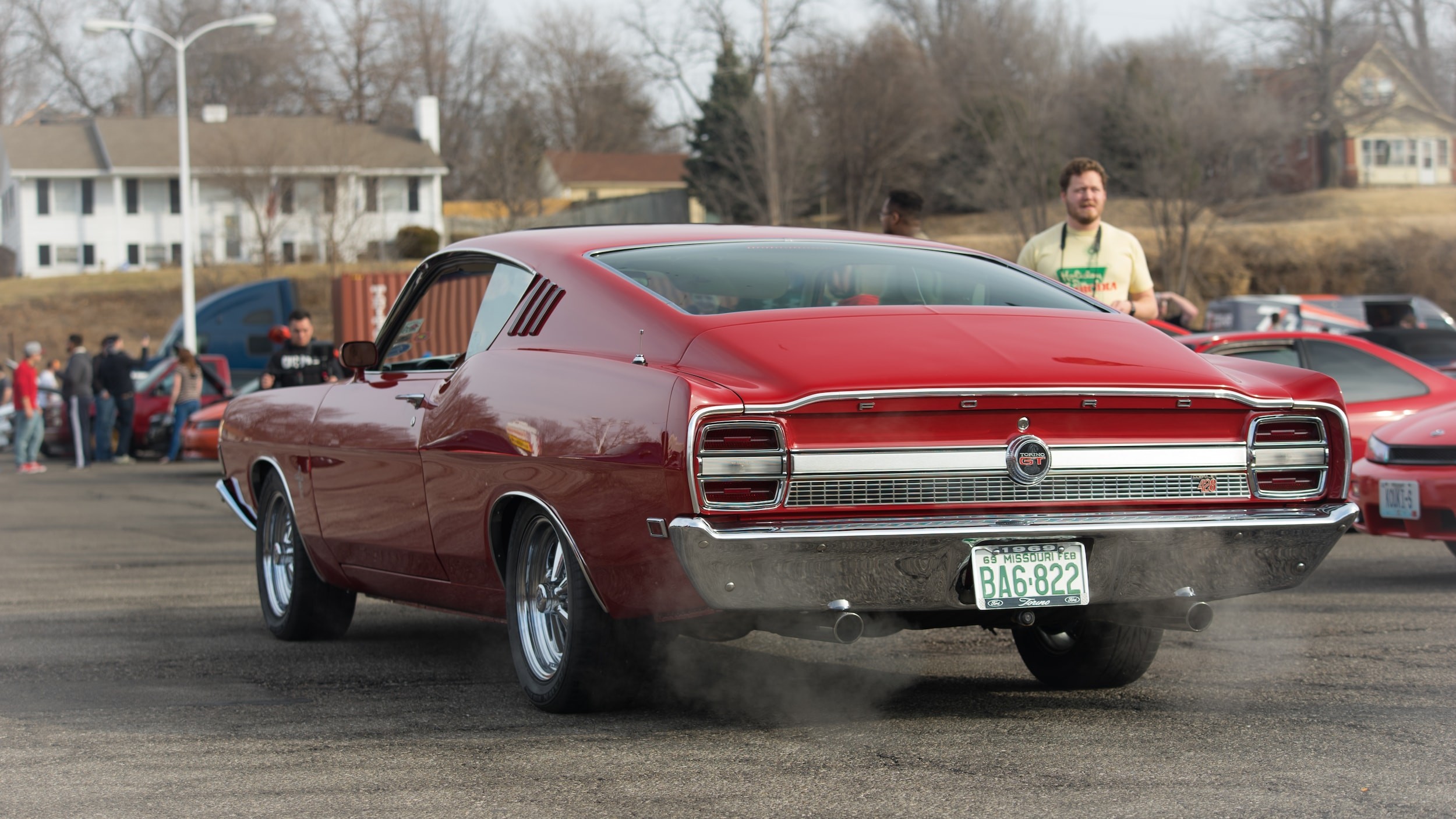 Enthusiasts gathered at a car meet, showcasing the community aspect of learning about cars