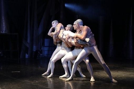 Actors performing on stage in a community theatre