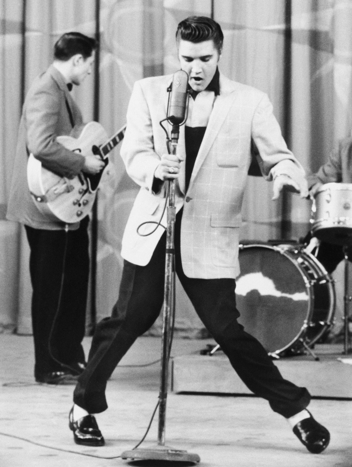 Black and white photo of Elvis Presley performing 