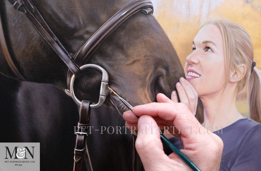 Close-up of a hand using various pencils to create a detailed portrait drawing