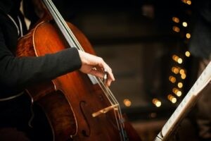 Man playing the cello in a band