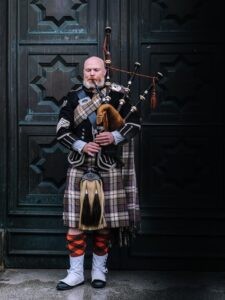 Scottish man playing the bagpipes