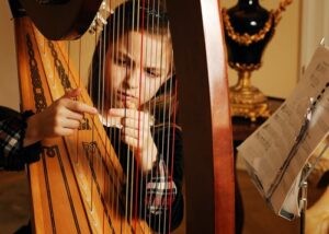 Young girl playing the harp