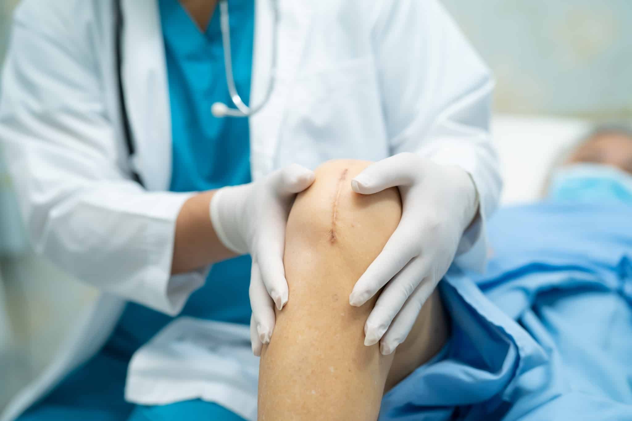Healthcare professional assessing stitches