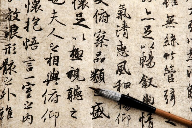 A person studying Chinese characters with flashcards, highlighting the organized system and radicals that make character memorization more manageable