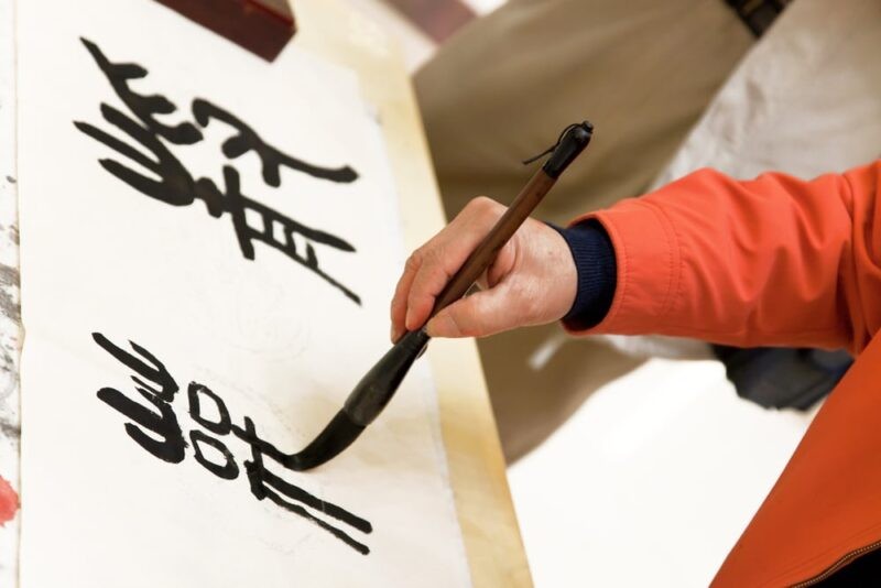 A person typing Chinese characters on a computer keyboard, demonstrating the shift from handwriting to digital input in modern China