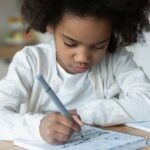 Young girl confidently solving math problems