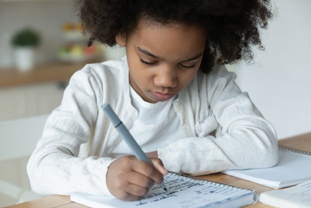 Young girl confidently solving math problems