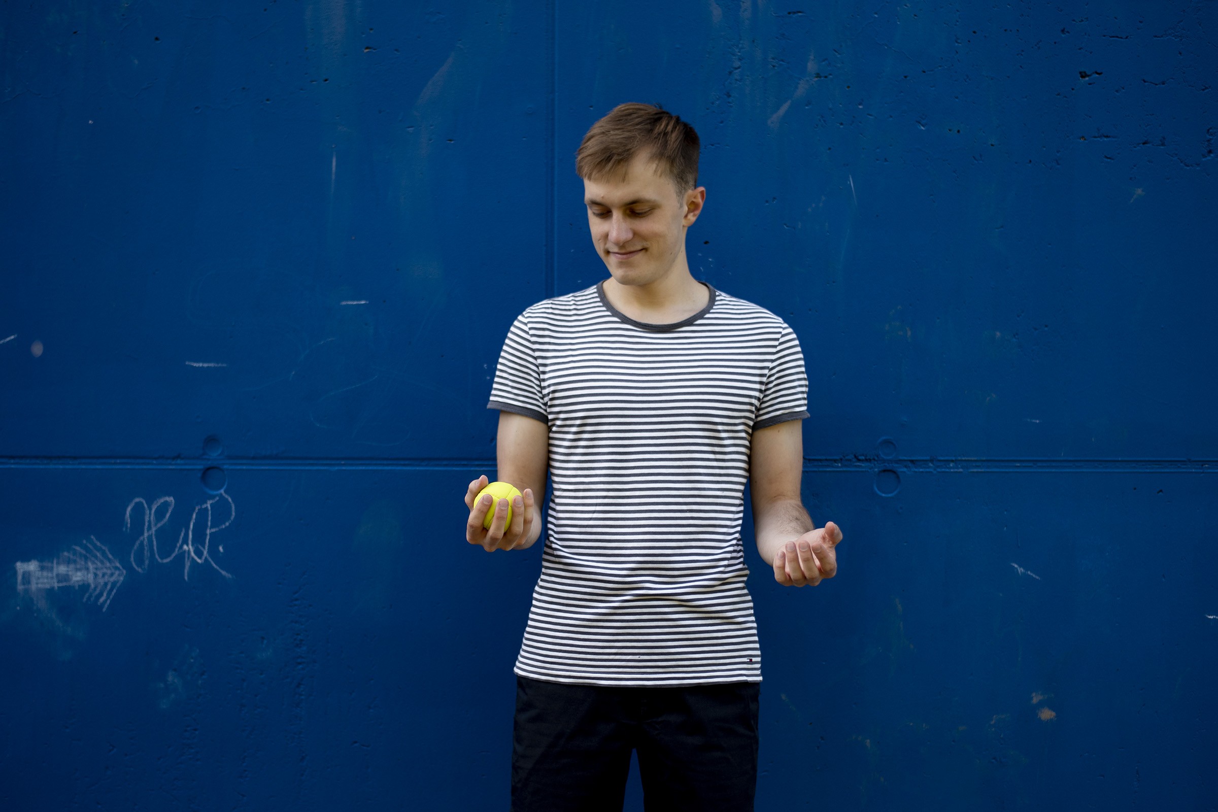 Hand throwing juggling ball upwards