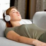 Woman peacefully sleeping while listening to Spanish lessons