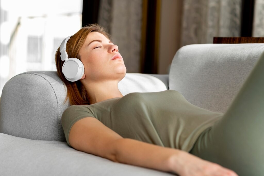 Woman peacefully sleeping while listening to Spanish lessons