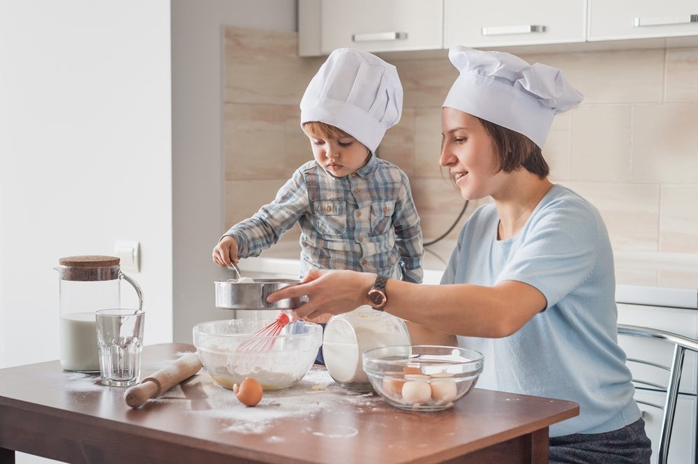 A mother and child baking cookies together, reinforcing language development and sensory skills
