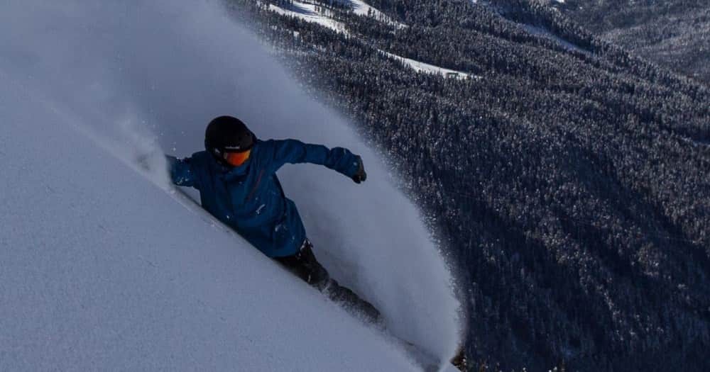 Snowboarder gliding through powder snow
