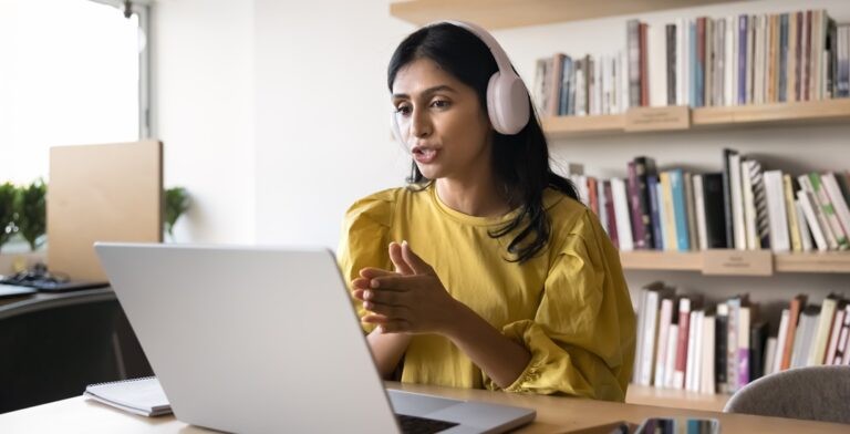 Woman in front of her laptop learning a language with one of the best online language schools
